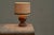 A lovely table lamp with a base in carved wood with a shade in woven jute. Probably french, 1960s. The lamp features a...
