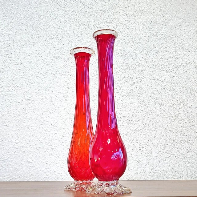 Carnelian red, mouth-blown, Murano glass bud vase by BAROVIER & TOSO featuring a ruffled, clear glass base, and a clear...
