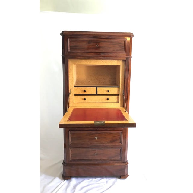 A refined 19th century mahogany secrétaire chest executed in the French Empire and Biedermeier taste, featuring a...