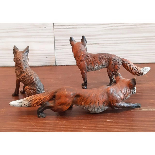 Set of three Austrian bronze hand painted miniature fox sculptures, circa 2000s. These pieces have amazing detail and...