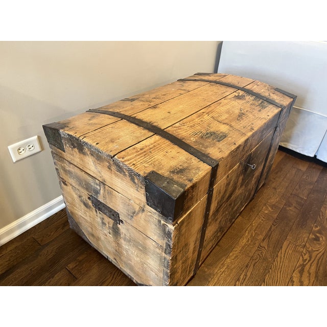 Antique wood storage trunk with iron strapping and edges. Original skeleton key and lock. Purchased from a dealer in...