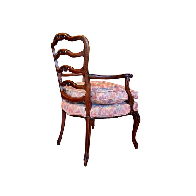 A beautiful mahogany arm chair featuring finely carved detail. Ribbon rails are accented by delicate scrolls while arms...