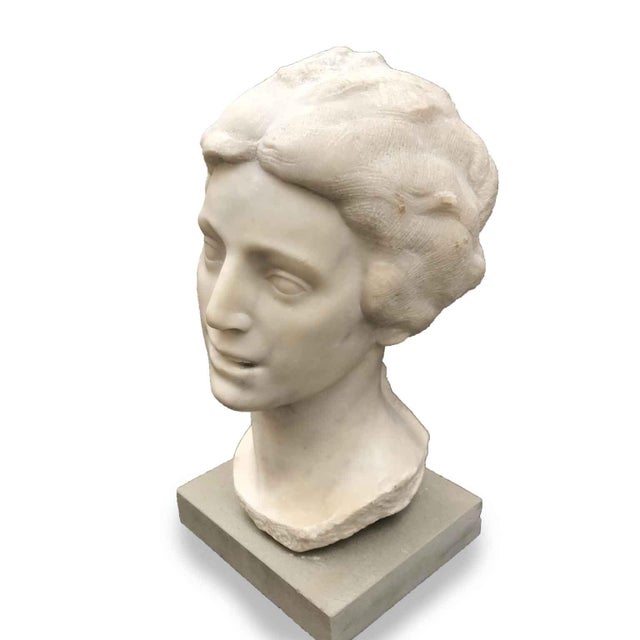 Aurelio Bossi, Bust of a Woman in White Marble, signed at the base on the front, with a modern pietra serena pedestal. The...