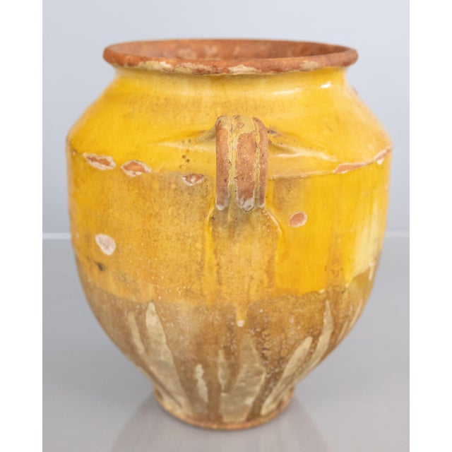 A lovely large antique 19th century French confit pot with drippy mustard yellow glaze from the South of France,...