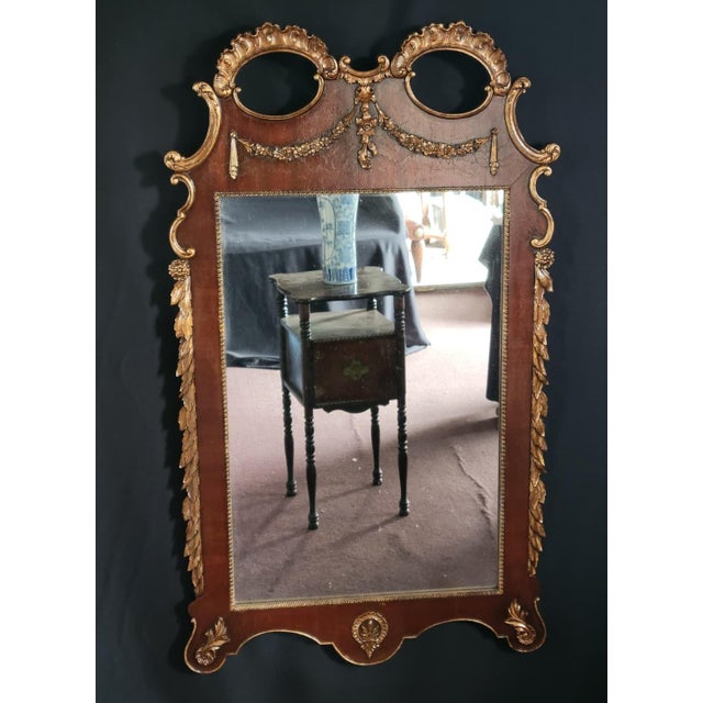 Beautiful c.1900 French wall mirror featuring a hand-carved wood frame with elegant gilt decoration and Neoclassical...