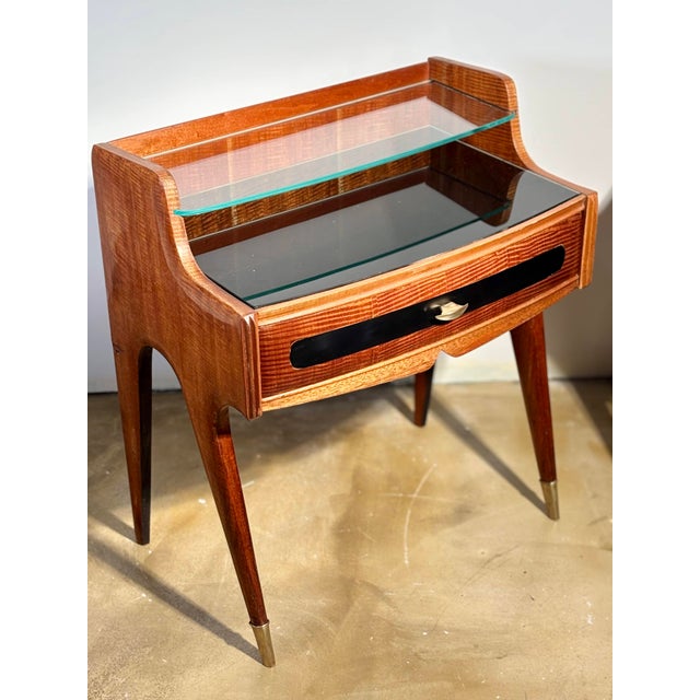 A remarkable pair of bedside tables (or end tables) in flame mahogany veneer, representative of prestigious Milanese...