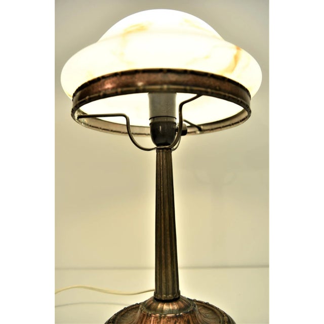 Swedish Grace Copper and Hand blown Glass Table Lamp 1920s. Punched copper base holding a hand blown glass shade most...