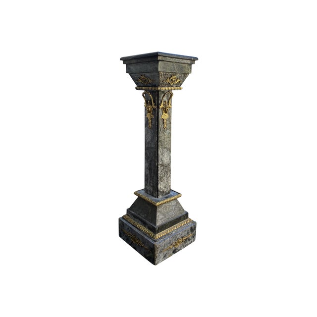 A beautiful, stunning statement pair of Italian neoclassical black marble pedestals with real bronze/brass gilted...