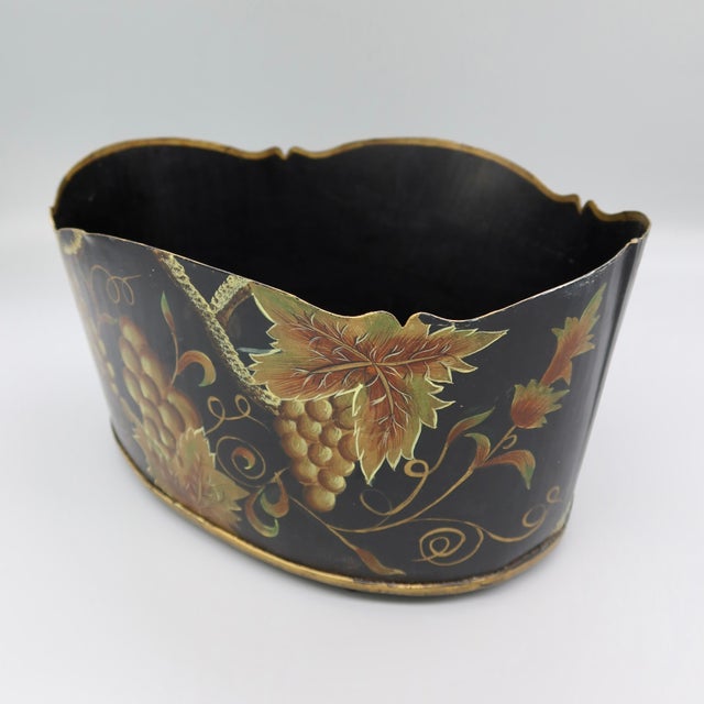 A hand-painted tole cachepot in the Monteith style — the scalloped, wave-edged rim characteristic of that form — set on...