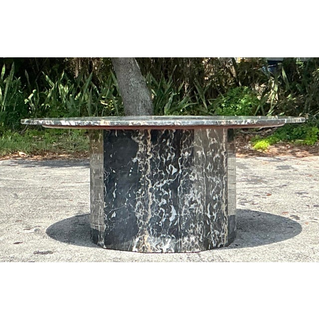 This monumental dining table is a masterclass in Postmodern design, featuring a substantial round top crafted from...