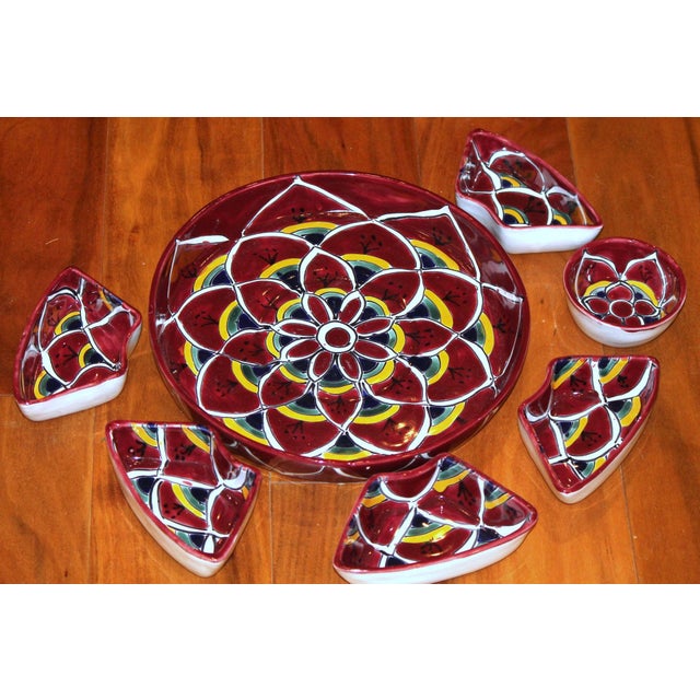 This gorgeous dish was made in Mexico in the Talavera style. It contains a platter, a small center bowl and 5 small,...