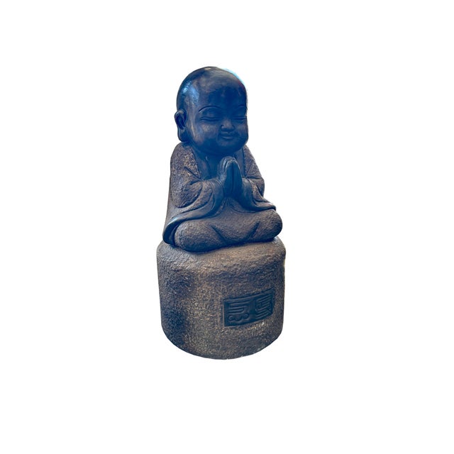 Invoke an atmosphere of quiet contemplation and timeless serenity with this charming stone-carved meditating young monk...