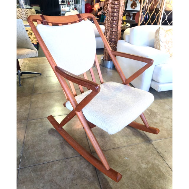 This solid teak, Danish modern rocking chair was designed by Benny Linden. It's original cream and beige upholstery is in...