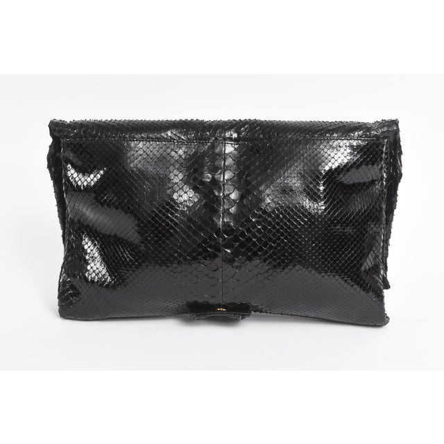 This stunning Valentino black python bag or clutch has a removable shoulder strap so it becomes two kinds of handbags in...