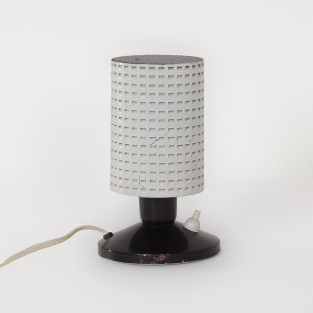 Hala table lamp model “Fiesta” designed by H. Busquet in ca. 1960. The perforated metal shade creates a nice light effect....