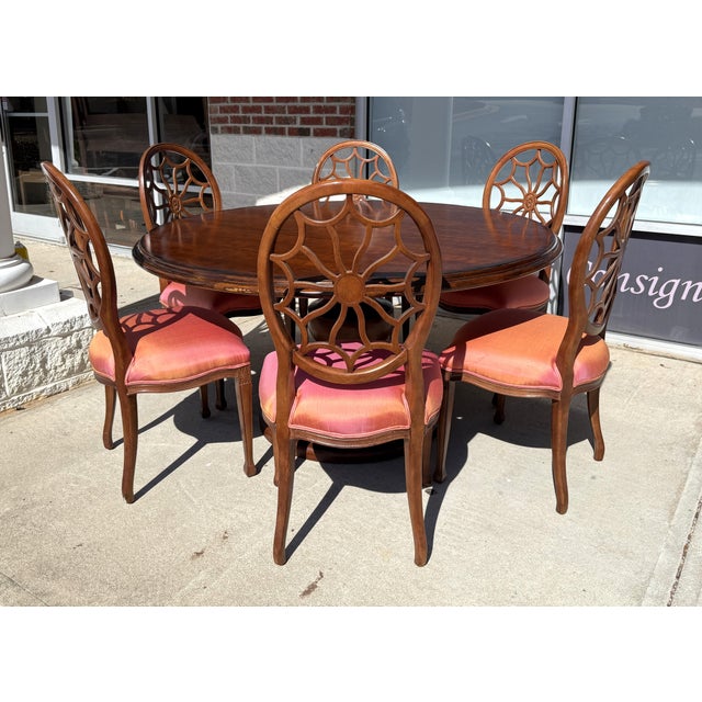 This elegant 7-piece dining set features a 5-foot round table with a rich, warm wood finish and a distinctive pedestal...