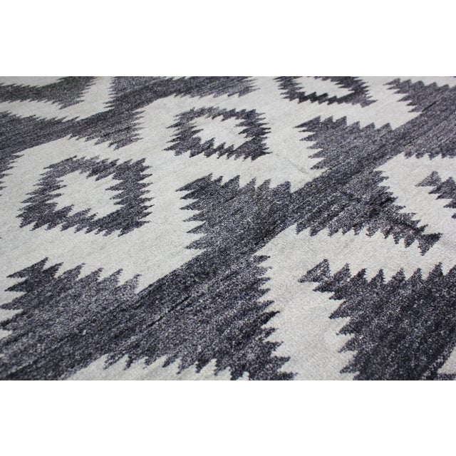 A beautiful handmade environmentally friendly Bamboo and silk rug, with a geometric design is made of 75% bamboo silk and...