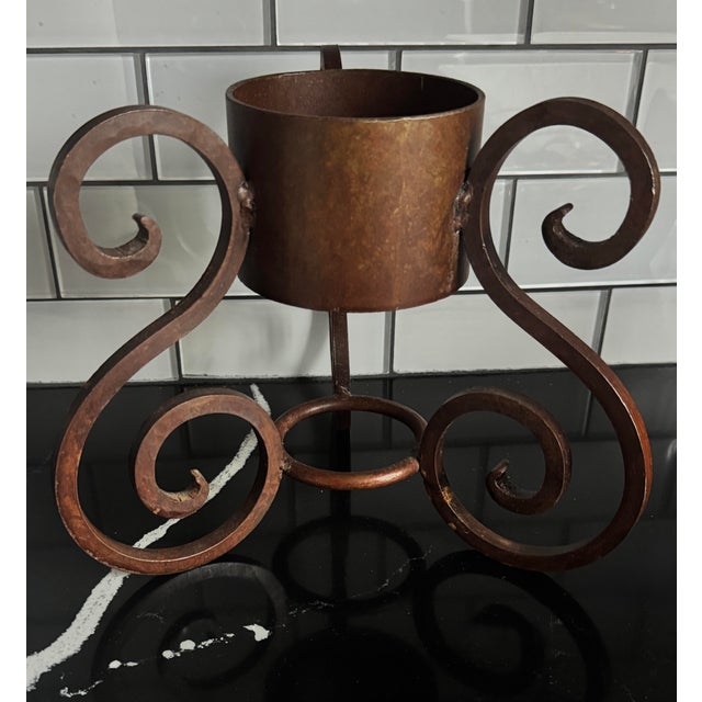 Vintage 1960s hand-forged wrought iron planter or cachepot stand with classic scroll design and natural aged iron patina....