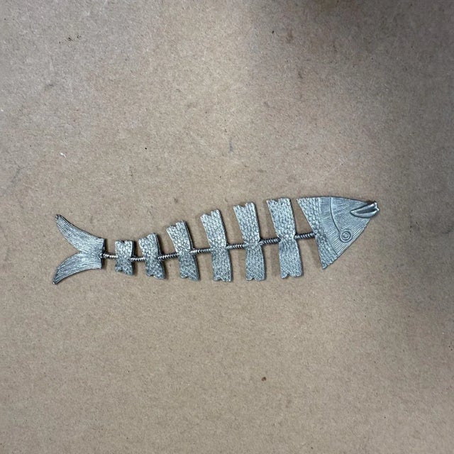 For your consideration, a hand crafted articulated fish bone skeleton figure decoration. Taxco, Mexico. No stamp. Hammered...