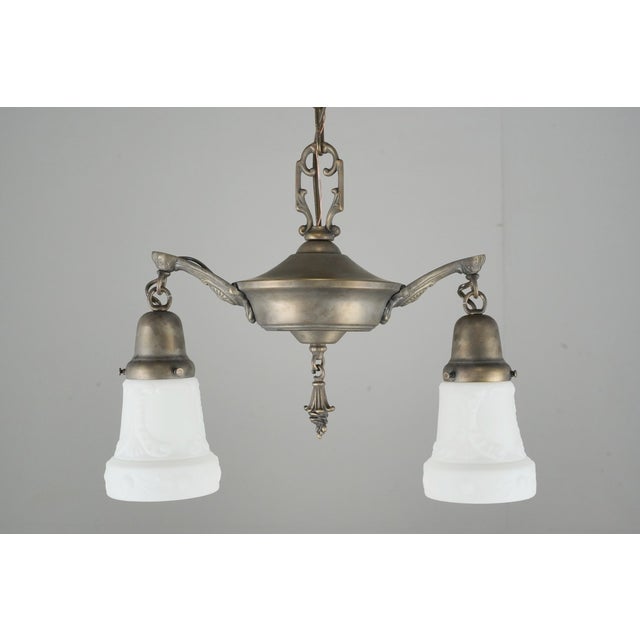 Victorian style pendant light made of brass with white cast glass shades. The chain is made of steel. This requires two...
