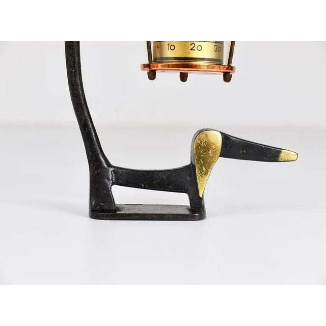 A very charming Austrian Mid-Century desk thermometer, consisting of a nice wiener dog / sausage dog figurine made of...