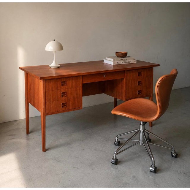 Freestanding Danish teak desk from the 1960s. Six side drawers, a central drawer and a fully finished back.
