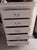 White coastal style wood chest 5 drawer Style: coastal Color: White Dimensions: 31 1/2" W x 48" H x 15 1/2" D