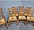 A super set of eight golden oak ladder backed dining chairs with rush seats, includes two carvers, in excellent overall...