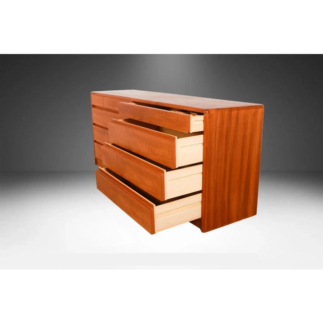 Attractive long, low, Danish modern, sleek, smooth face, teak 10 drawer dresser. A minimalistic teak double dresser by...