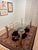 A sleek, postmodern glass dining table with four polished chrome-plated legs — a striking example of 1980s/90s design,...