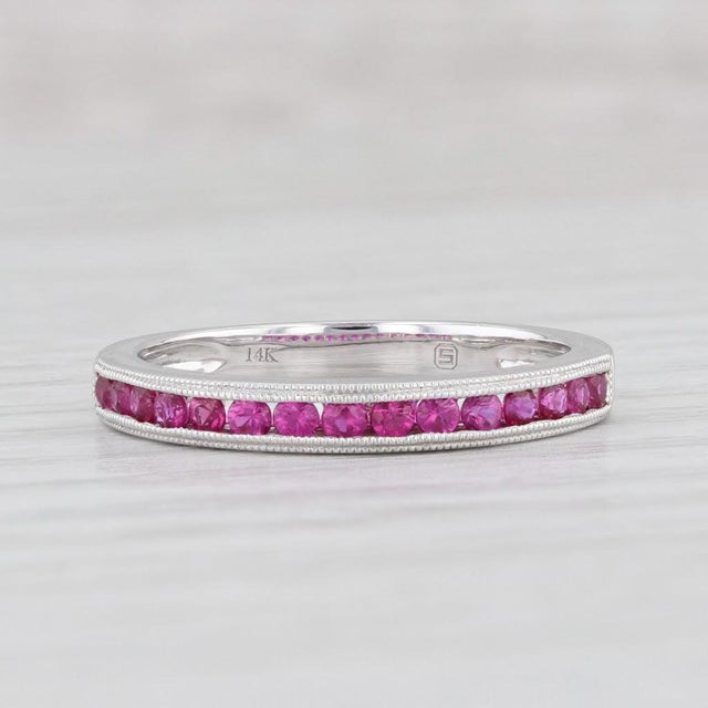 Gemstone Information: - Natural Sapphires - Total Carats - 0.30ctw Cut - Round Brilliant Color - Magenta Pink Treatment -...