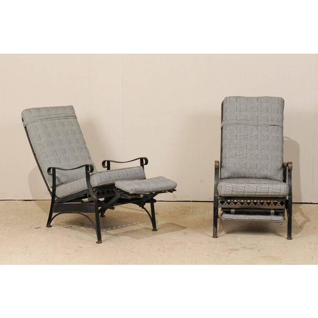 A pair of American Mid-Century reclining patio chairs. This pair of vintage iron patio chairs from the mid-20th century...