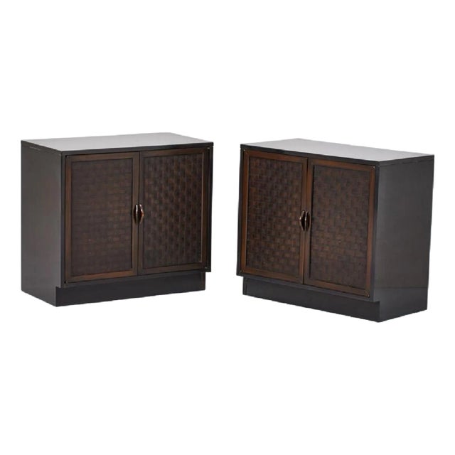 This is a pair of ebonized mahogany cabinets with basketweave fronts attributed to Lane Furniture. They open to an...