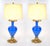 This elegant pair of antique table lamps features richly colored blue glass bodies, complemented by finely cast gilt...