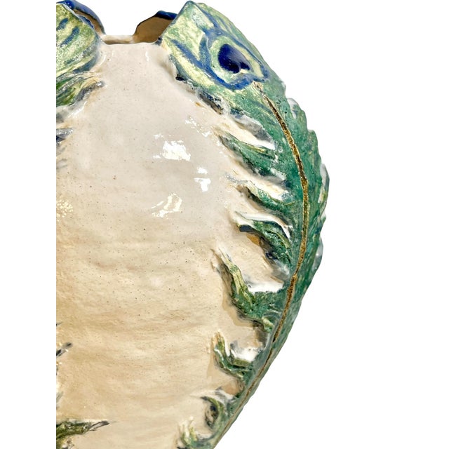 A wonderfully sculptural Italian vase featuring an organic hand-formed silhouette with raised green peacock feather...