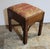 A handsome early 20th century mahogany stool in the Chippendale style, featuring rich, vibrant upholstery reminiscent of...