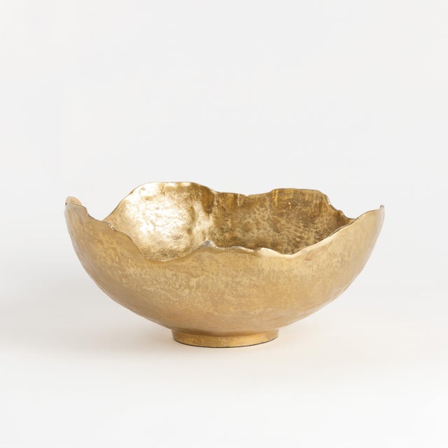 This organic decorative, hand-sculpted bowls is made to be on display. With a golden finish and irregular edge, styled or...