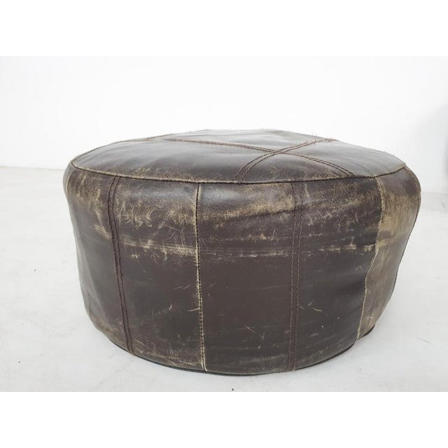 About this item Dark brown leather ottoman. The leather has some dis-coloration, some stitches are gone, but there are no...