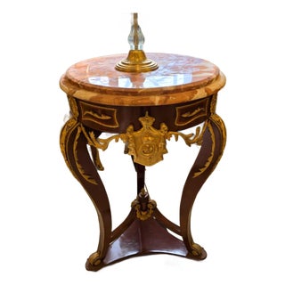 French Empire Marble Top Side Table With Gold Leaf Accents & Bronze Crest Detail For Sale