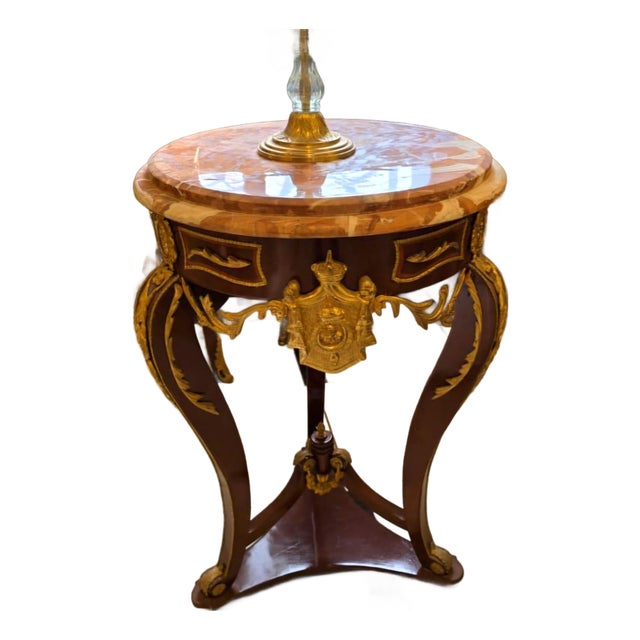 French Empire Marble Top Side Table With Gold Leaf Accents & Bronze Crest Detail For Sale