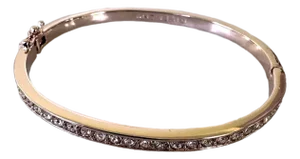 Givenchy Rose Gold-Tone Bangle Bracelet Featuring a Row of Inlaid Crystals and a Hinged Clasp.