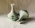 ….a perfectly matched pair of petite hand-painted French porcelain bud vases, brimming with the charm and artistry of the...