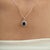 The Late 20th Century Royal 2.43 Ct Oval Blue Sapphire & Diamond Halo Pendant showcases a deep blue oval sapphire at the...