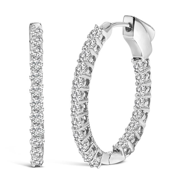 Indulge in the luminous elegance of these sophisticated hoop earrings, masterfully crafted from pristine 14K white gold....