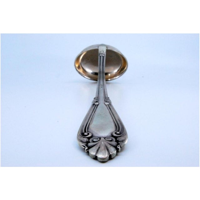 Silver Soup Ladle with Grooves Along the Handle with Reliefs Surrounding Monogram Card For Sale - Image 3 of 10