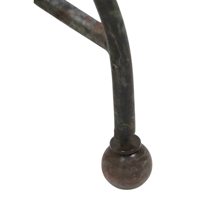 Wrought iron saddle seat window bench having a U shaped top with curlicue sides, over an opposing U shaped base, with...