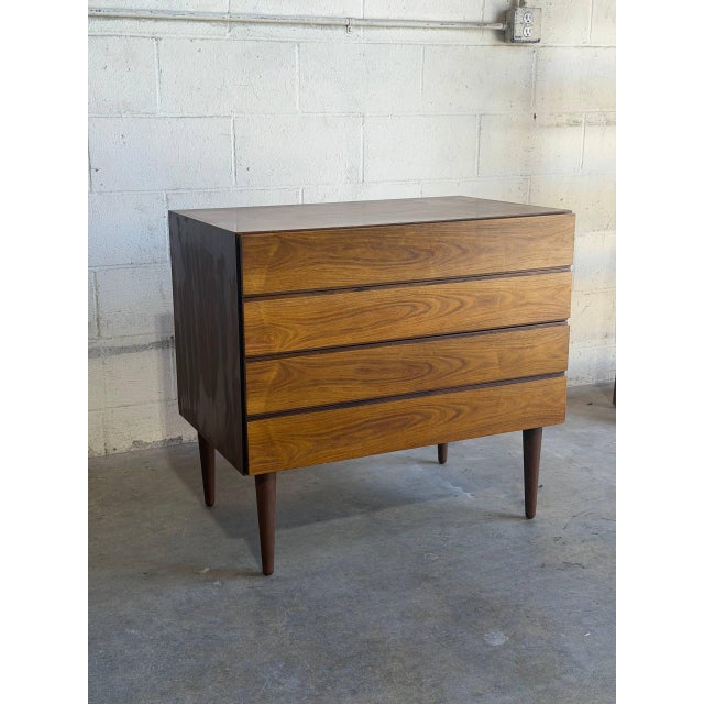 Beautiful vintage Danish modern rosewood chest featuring four spacious drawers, elegant minimalist lines, and stunning...