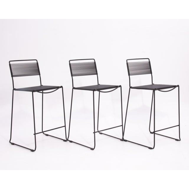 A set of three spaghetti barstools designed by Giandomenico Belotti, unmarked, circa 1980s. These stools have been...