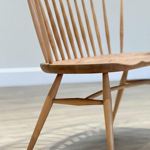 A graceful testament to enduring british design , this elegant love-seat was conceived by lucian ercolani and crafted by...