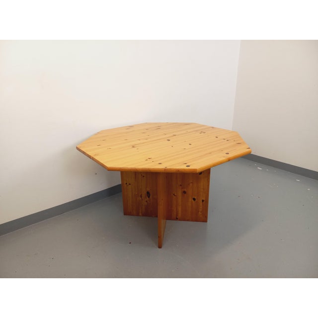 Vintage octagonal dining table from the 1980s, made of pine wood, with a central extension leaf and a four-sided cross...